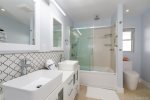 Guest Bathroom with Dual Sinks and Tub Shower